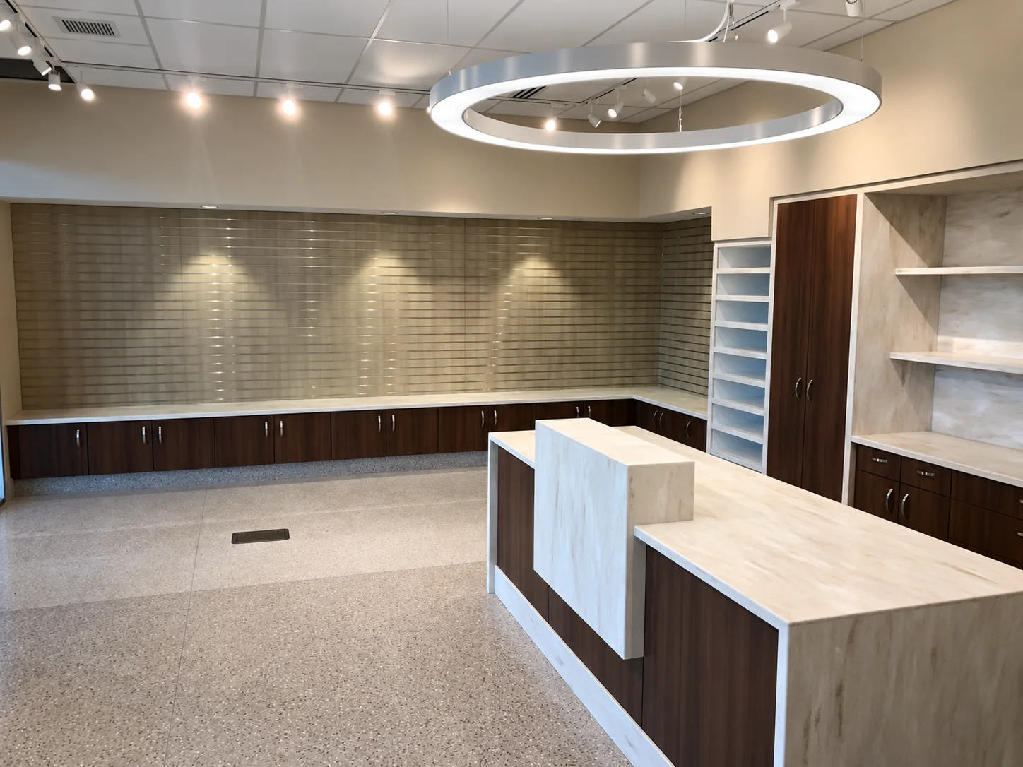 Retail display shelving and dark wood cabinets with a light-finished service counter.