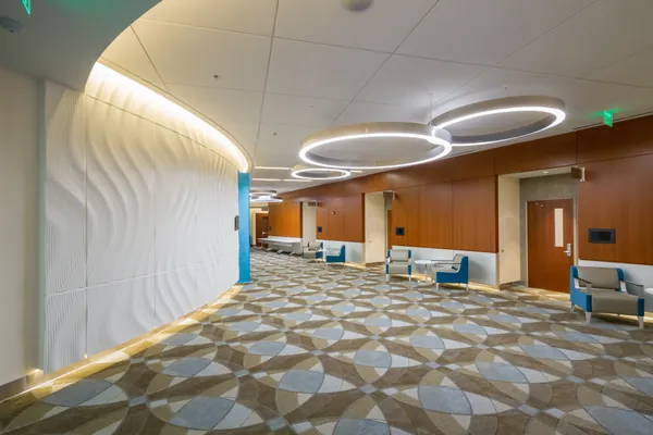 Lobby with sculpted wall and wood paneling at Radiation Oncology.